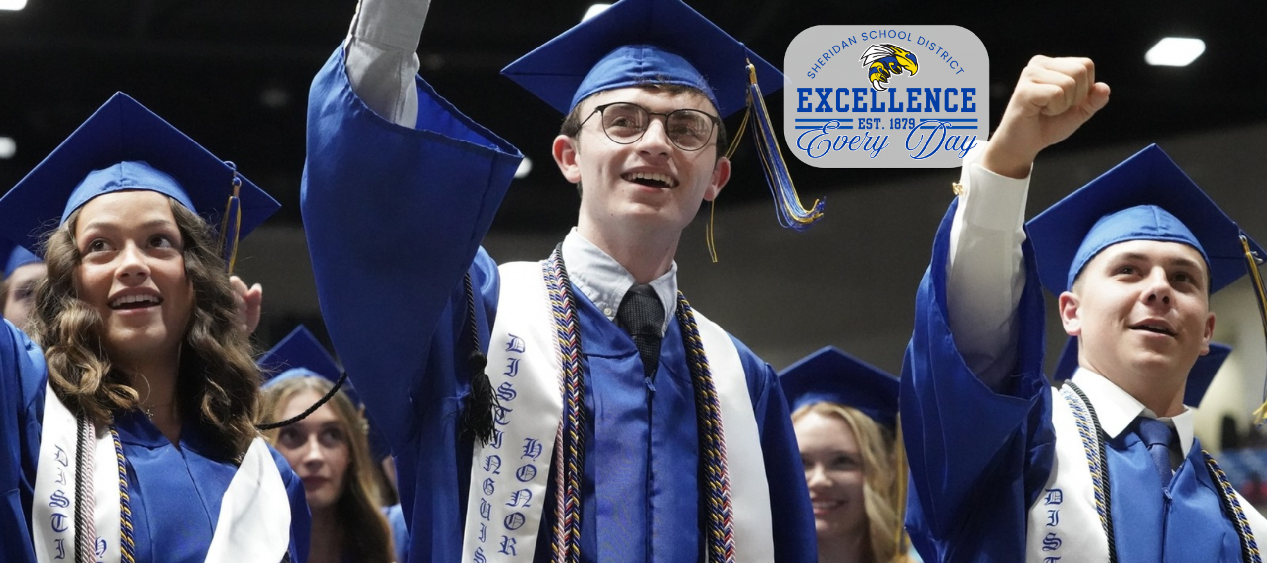 Students smiling in cap and gown