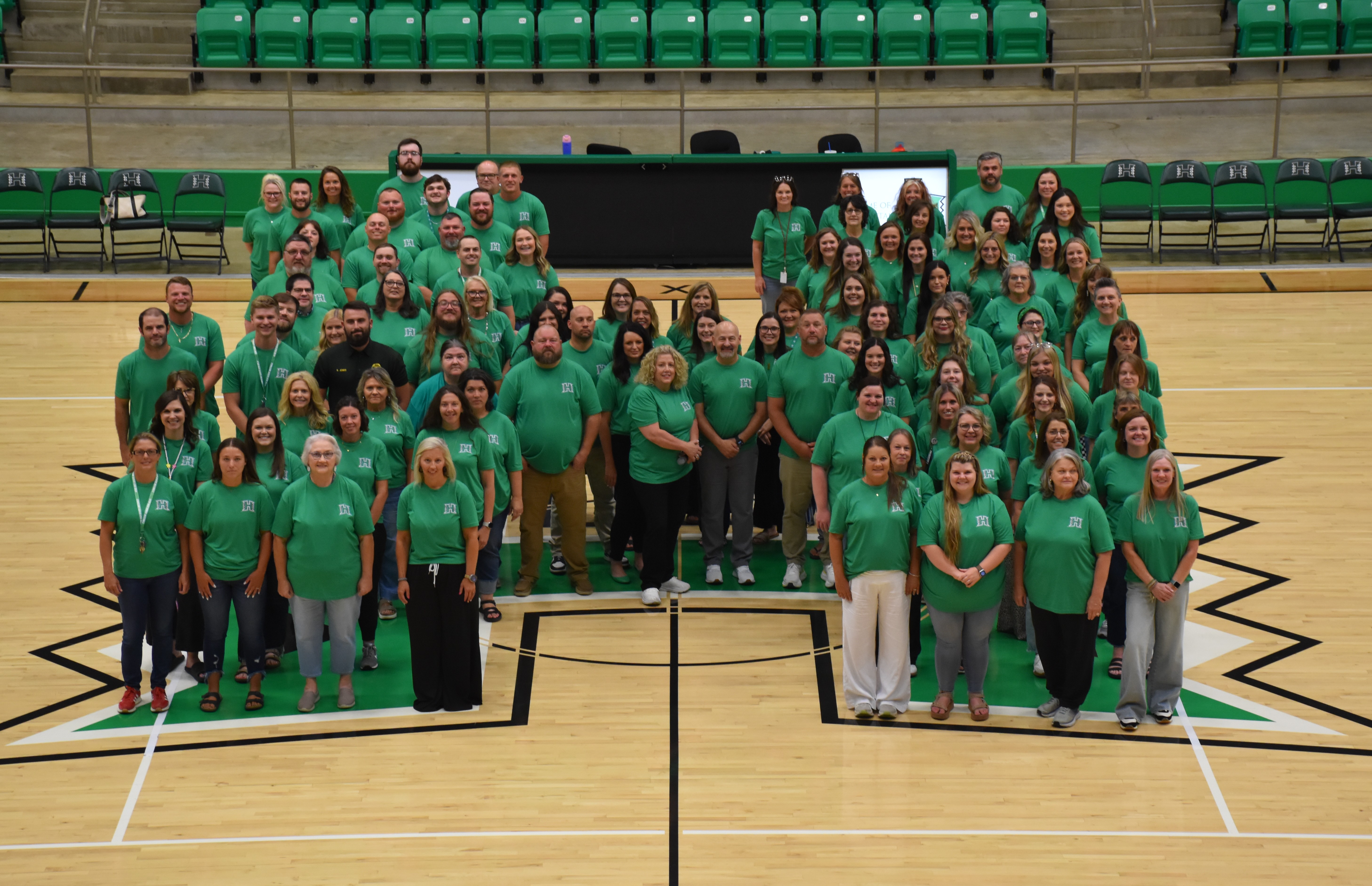 Hoxie Public School's Staff stand in the shape of a H.