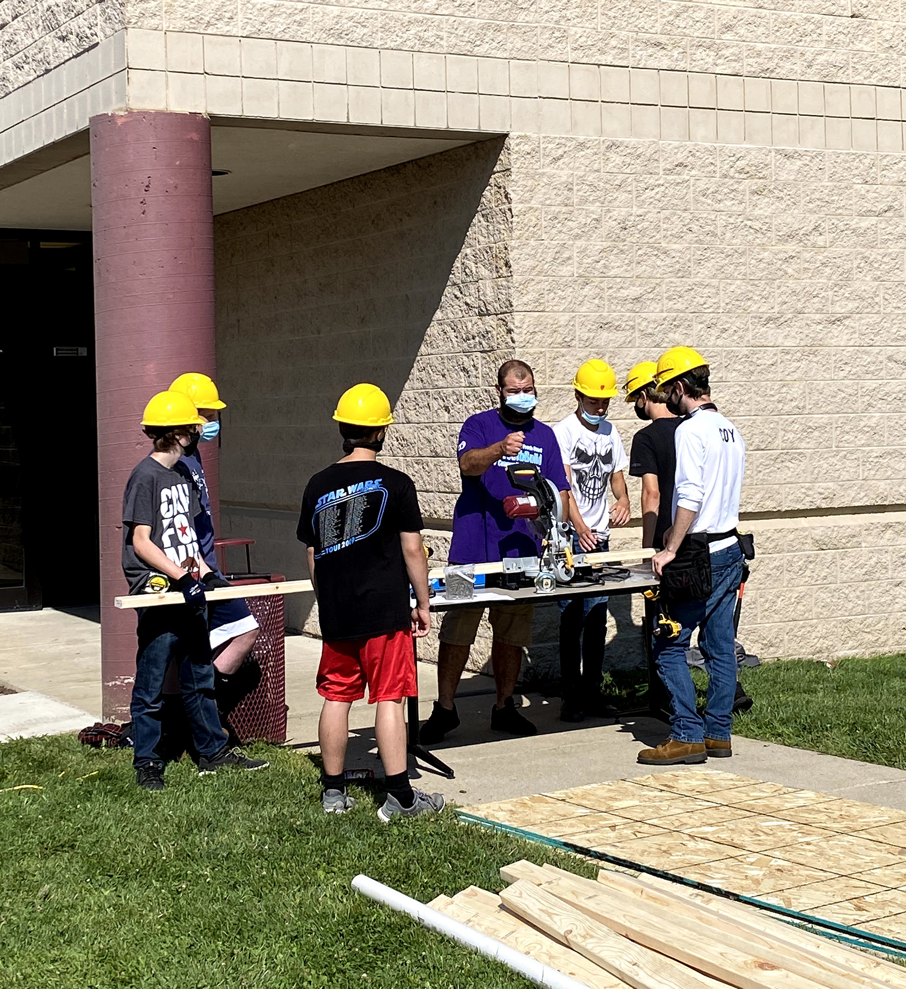 Youthbuild students watching sawzall demonstration