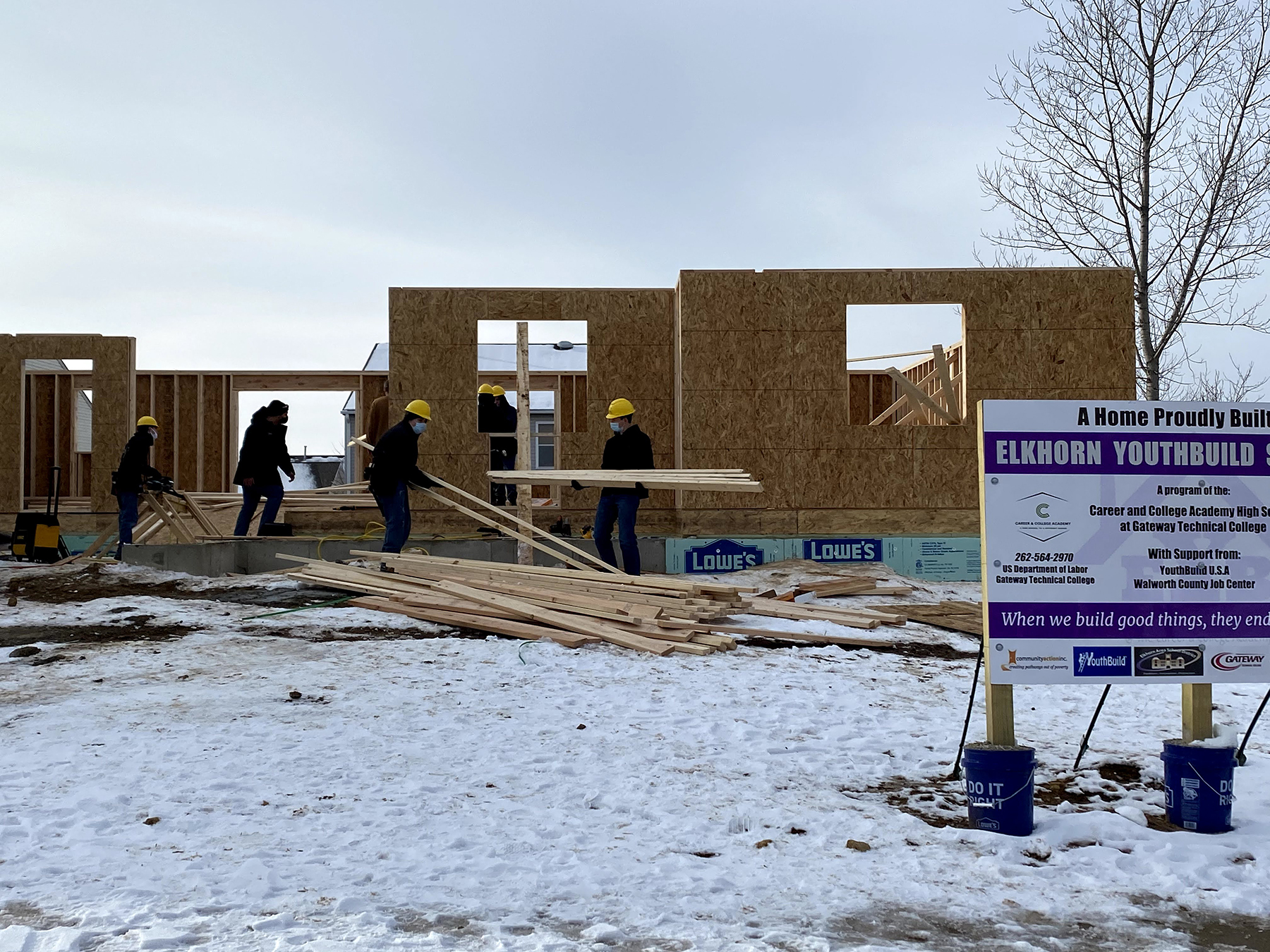 Youthbuild students working in the snow