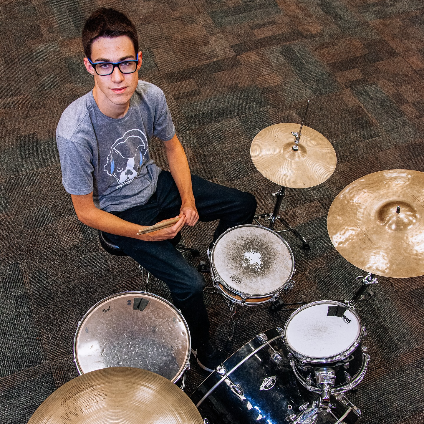 Tyson sits at his drumset