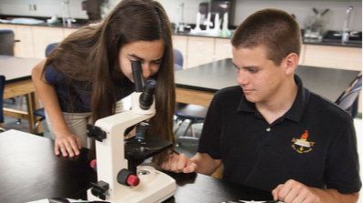 students looking in microscope