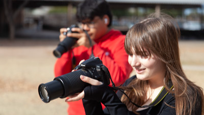 two students with cameras