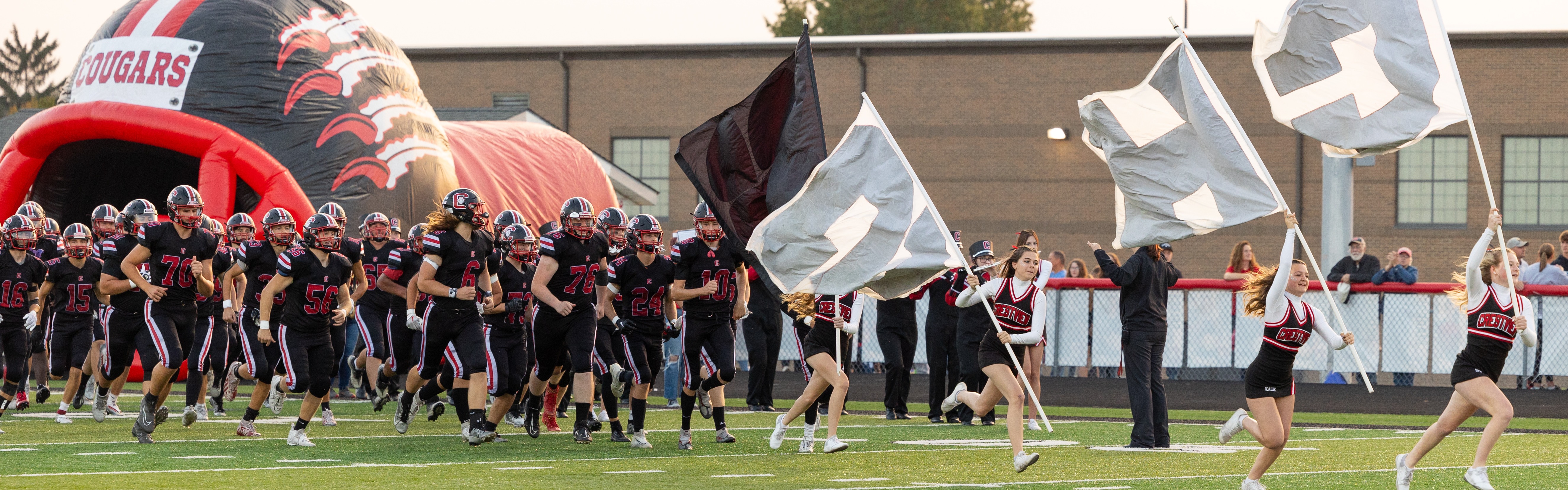 Teams runnning onto field