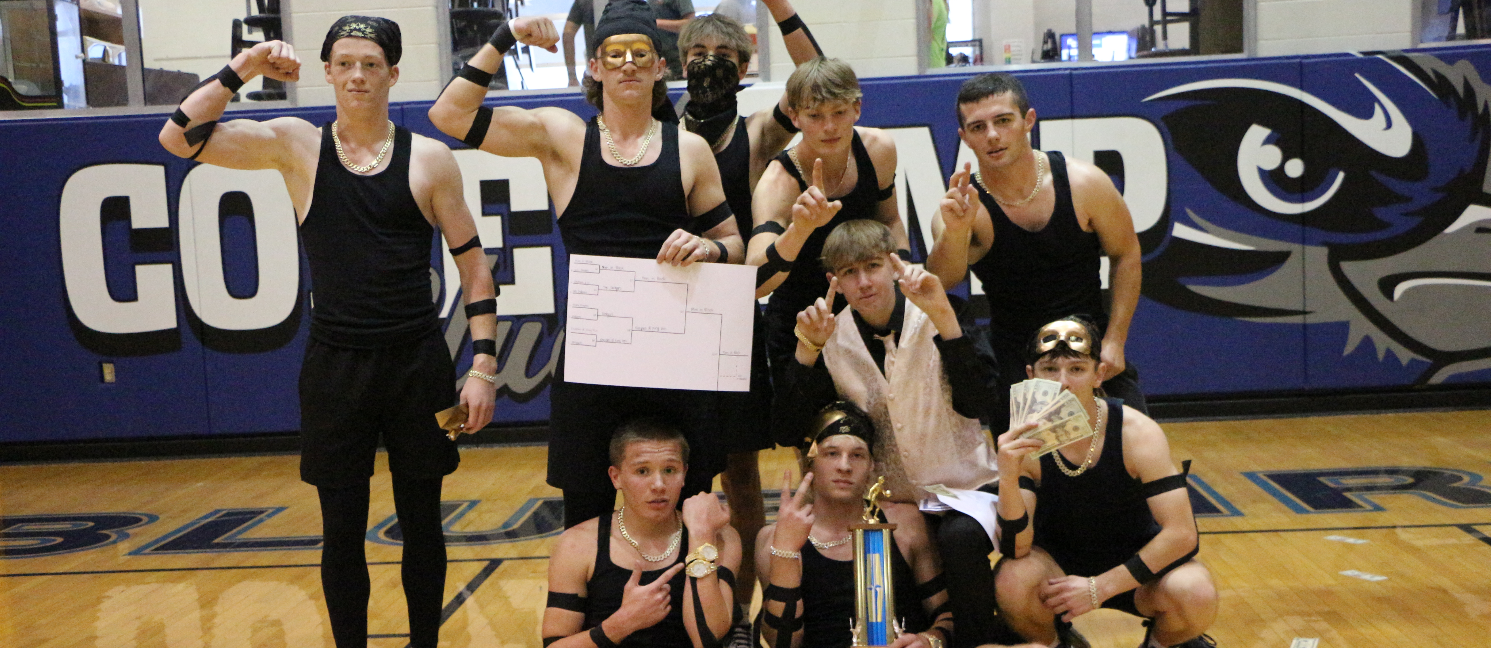 Student dodgeball team holding trophy