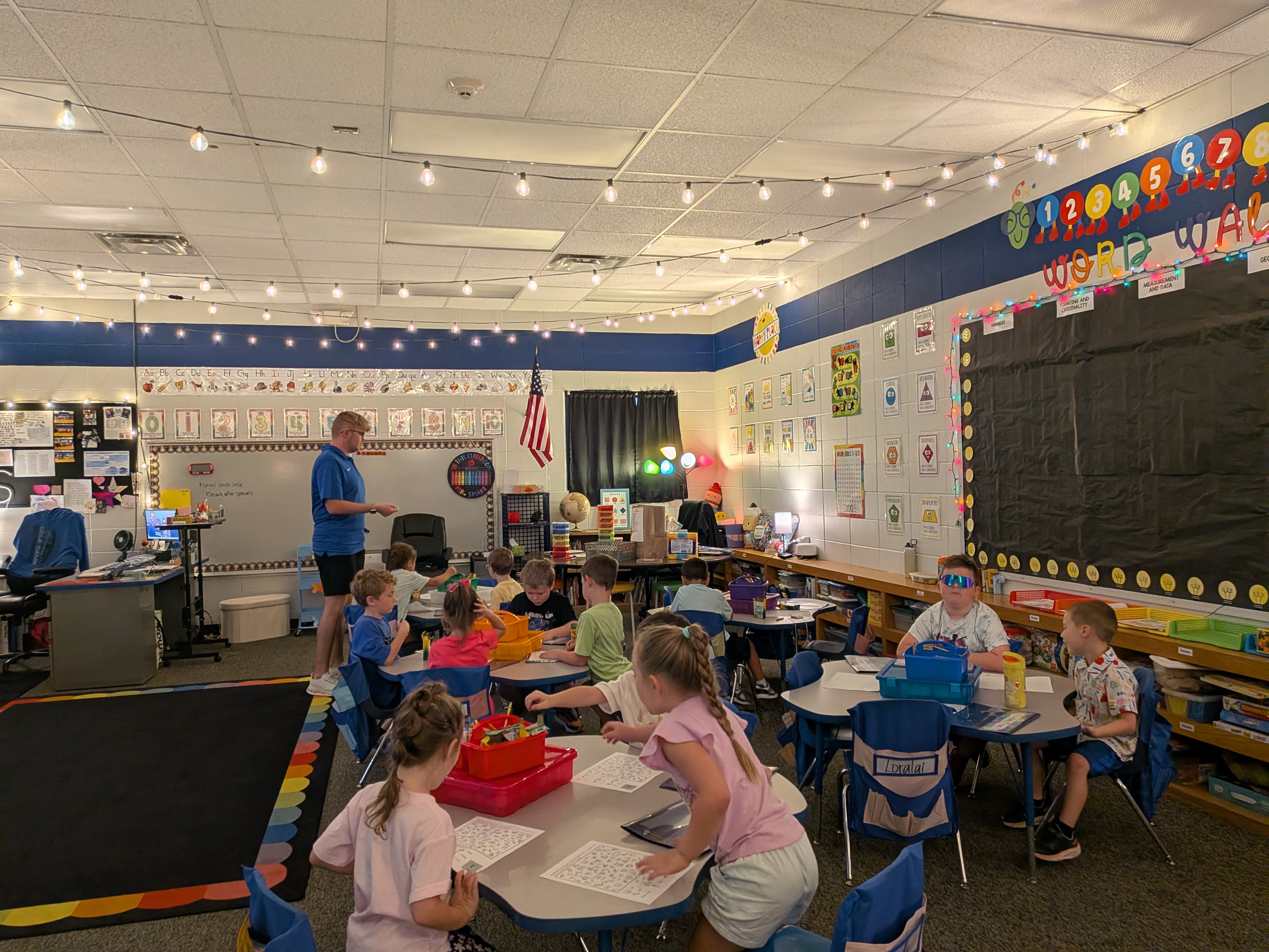 Kindergartens sitting at desk doing morning work.