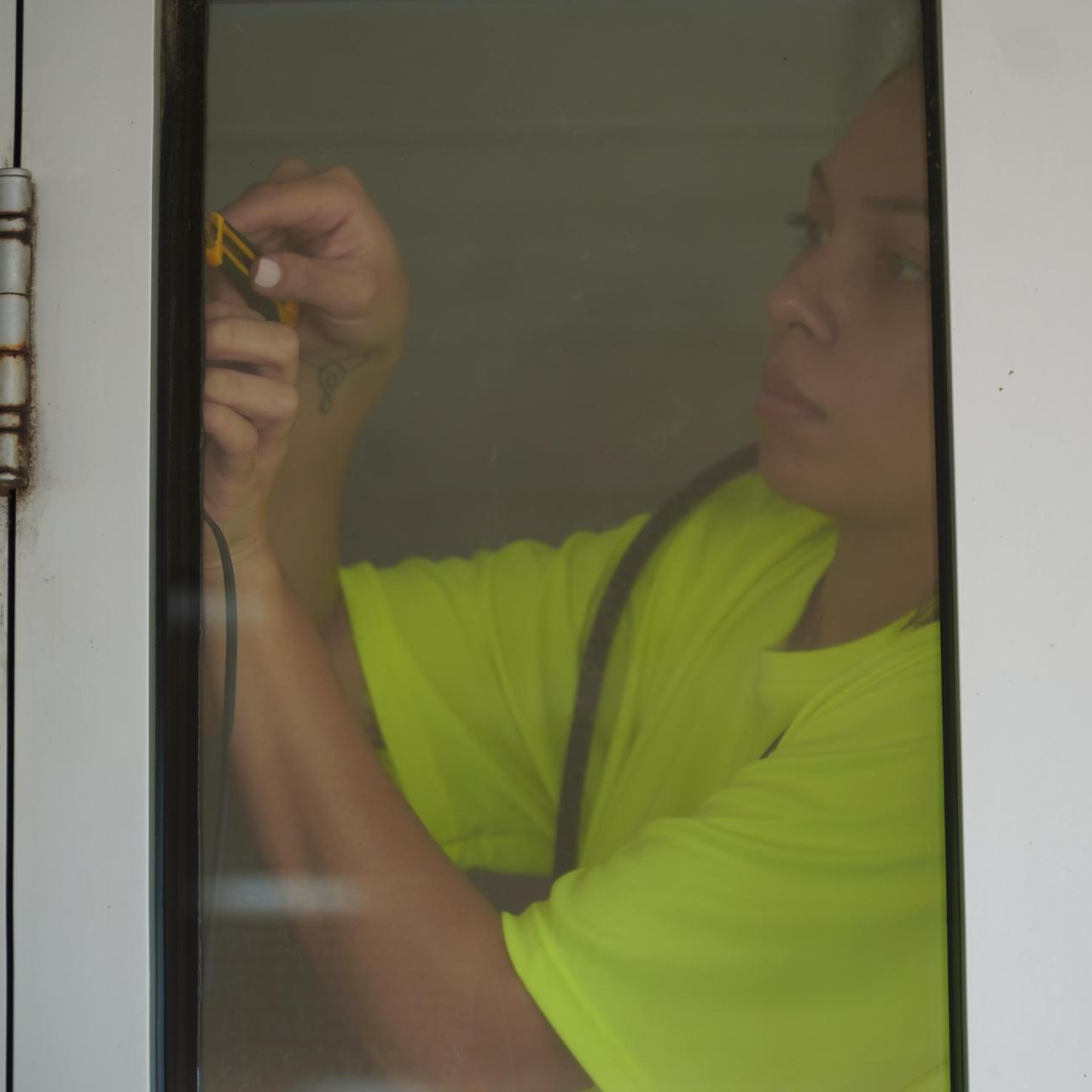 A woman working on a window