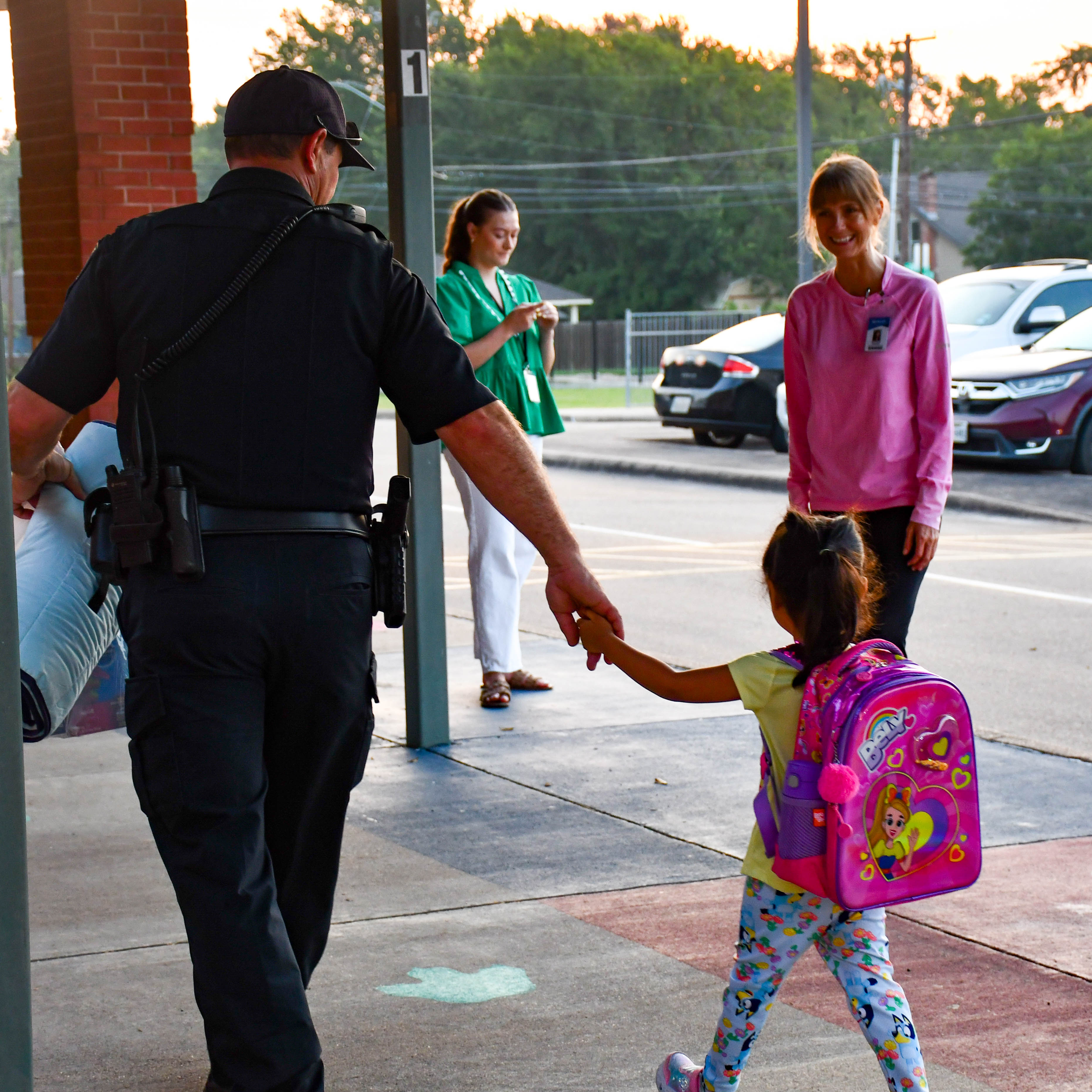 Fannin First Day - Police officer walking a new student into school