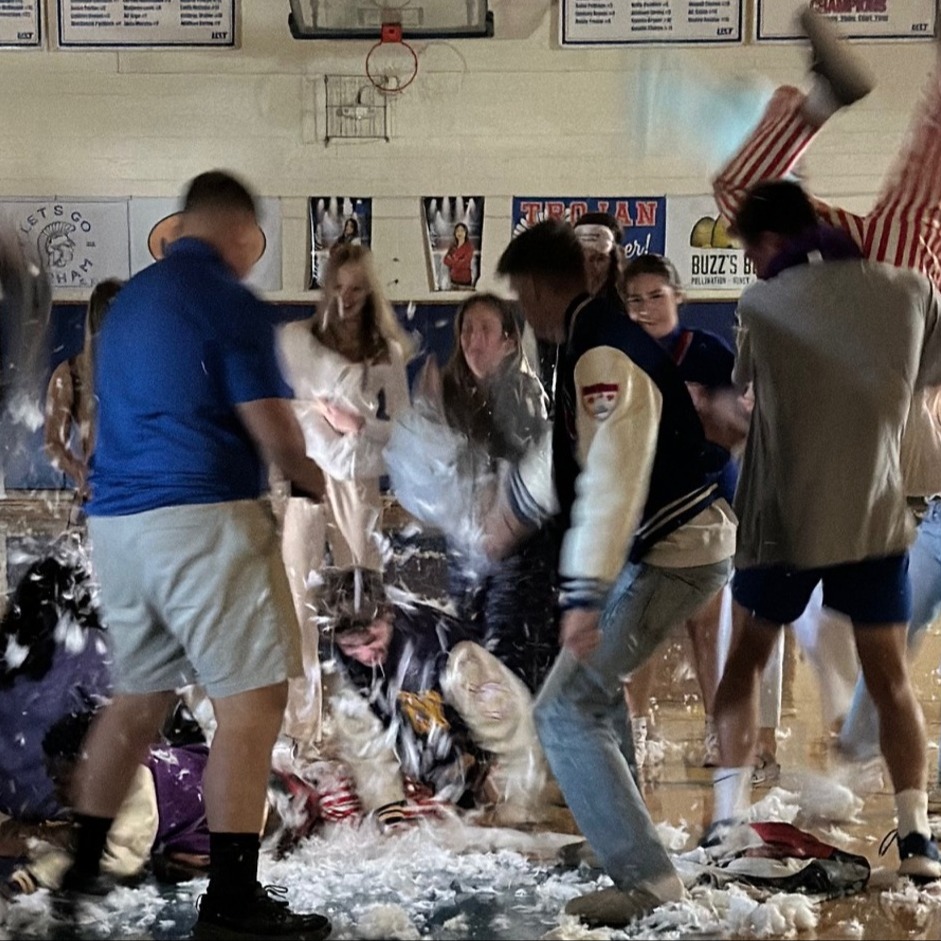 students throwing feathers in gym