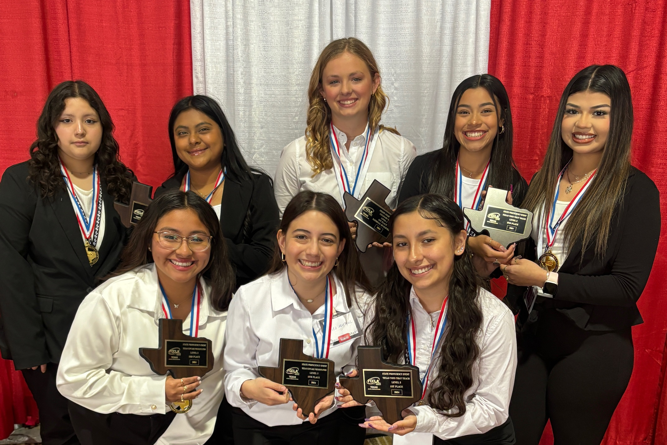 students holding plaques at contest