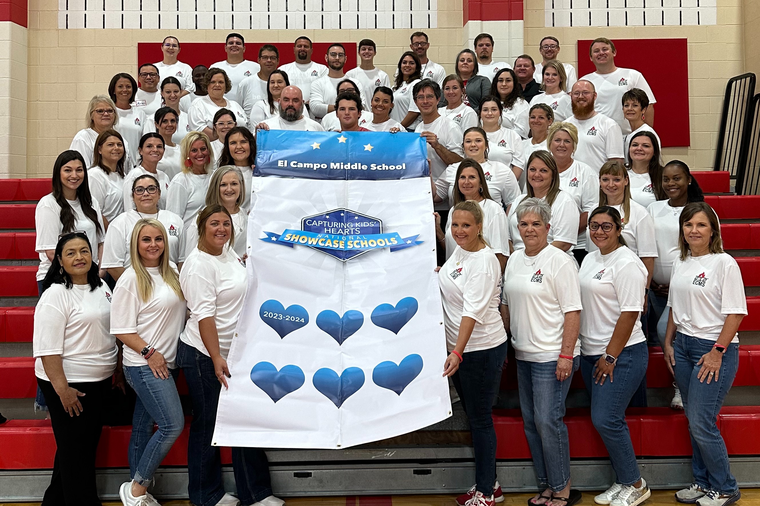 ecms staff with national showcase school banner