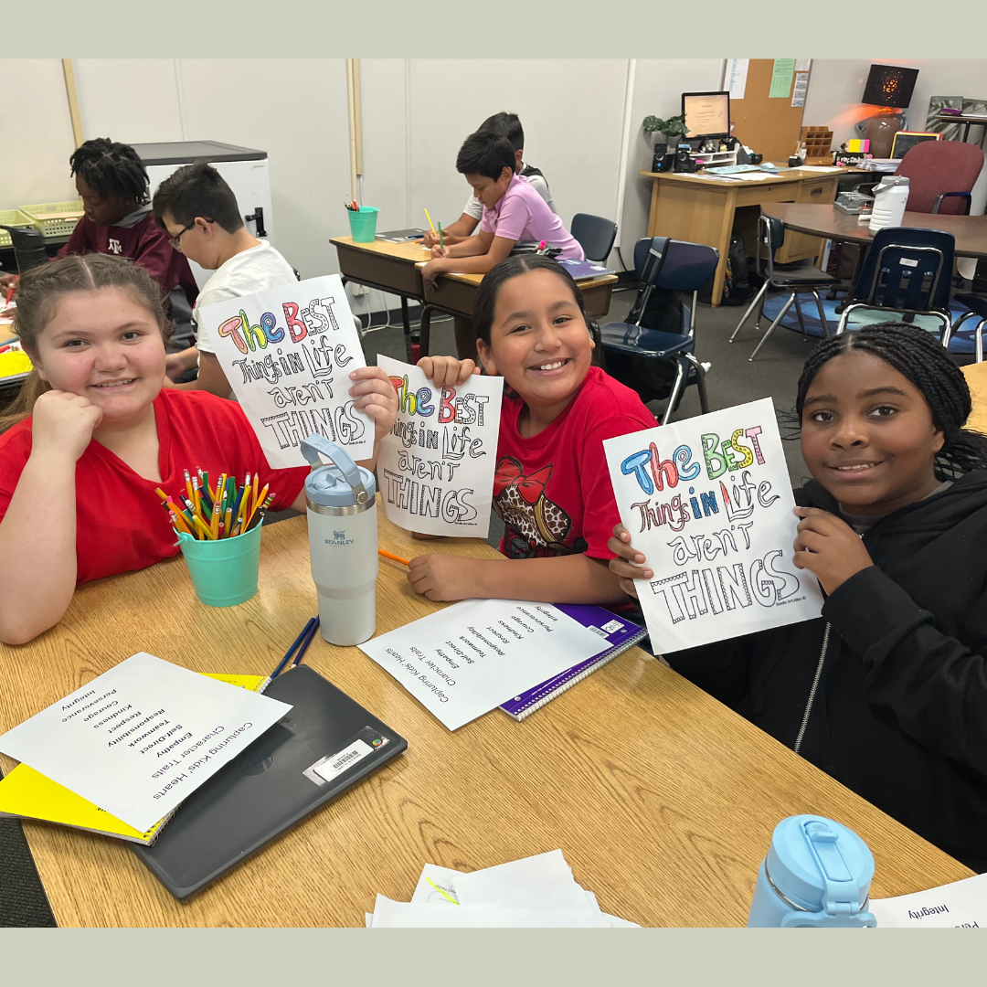 3 girls showing their journal covers