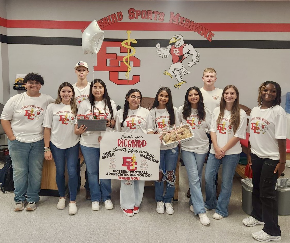 student trainers with thank you poster and goodies