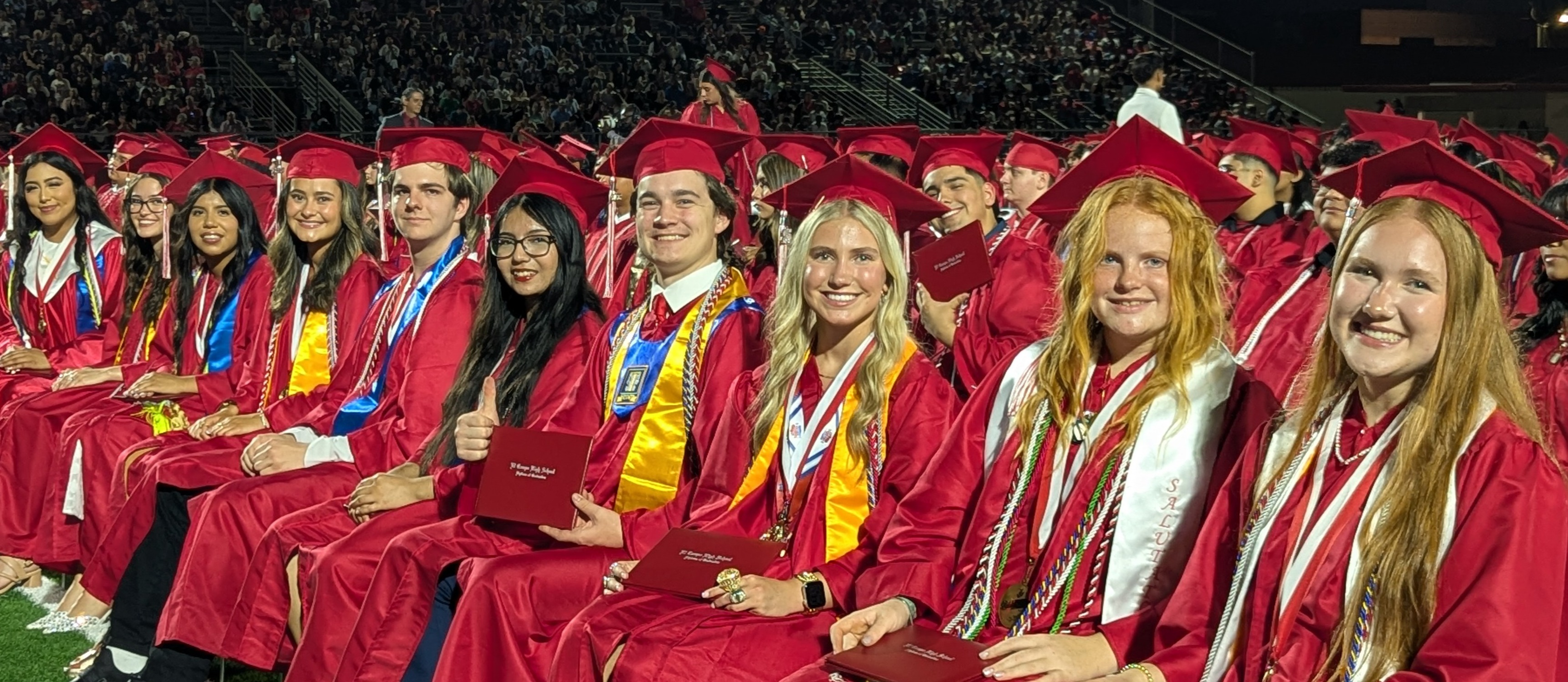 10 graduates sitting at graduation
