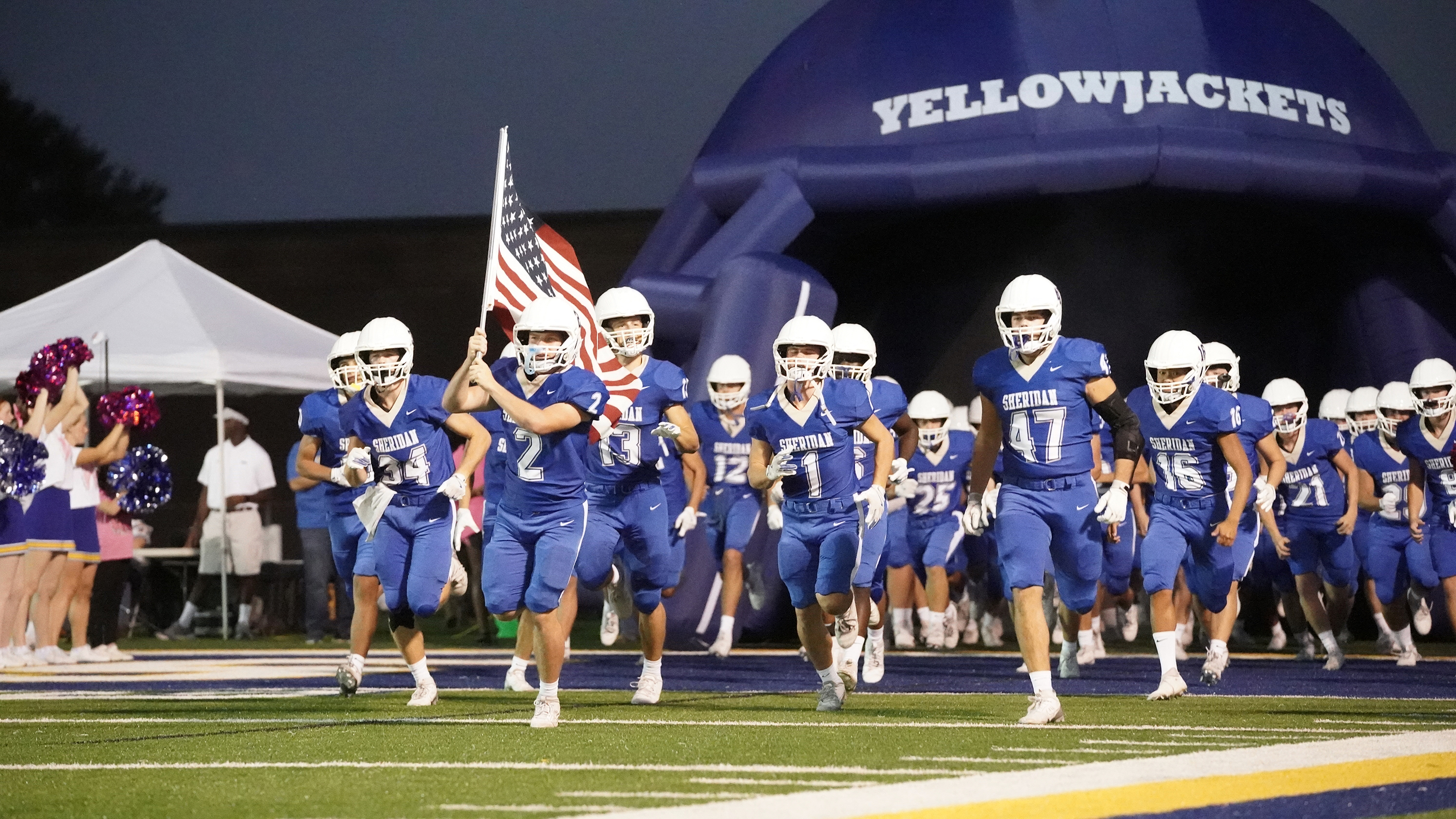 football team coming to field