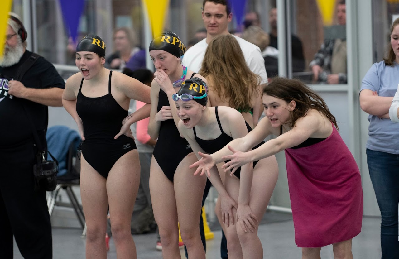 Swimming team at swimming pool practicing and having fun