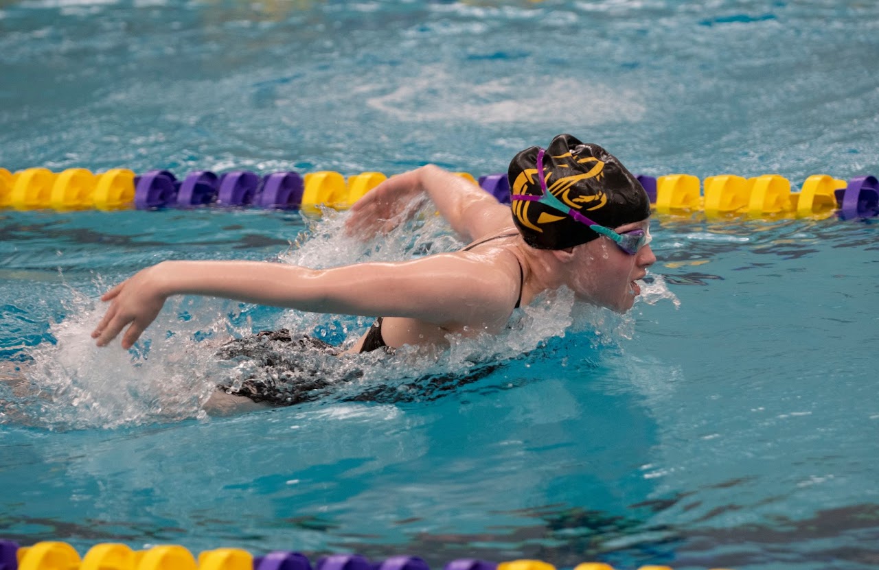 Swimming team at swimming pool practicing and having fun