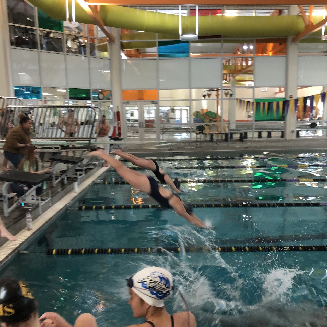 Swimming team at swimming pool practicing and having fun