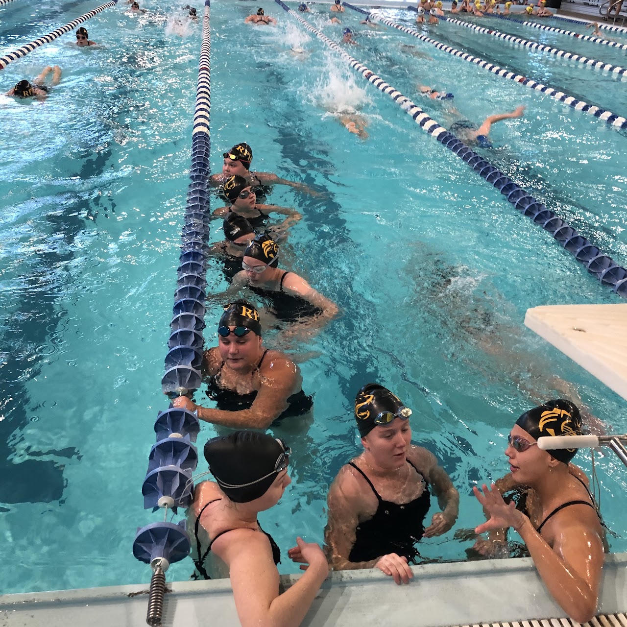 Swimming team at swimming pool practicing and having fun