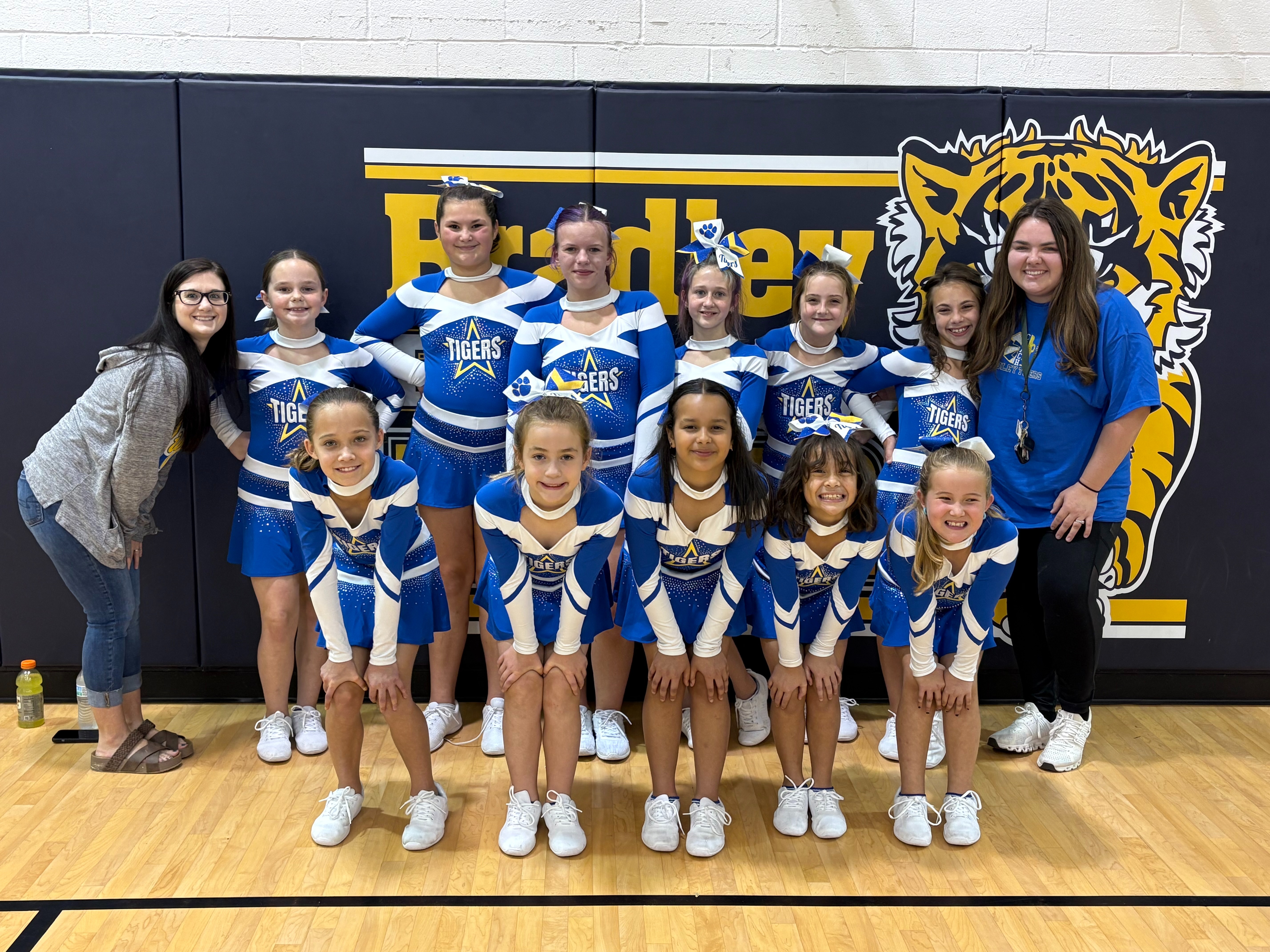 2025-2026 Bradley Elementary Cheerleaders posing with coaches in the Bradley Elementary gymnasium.