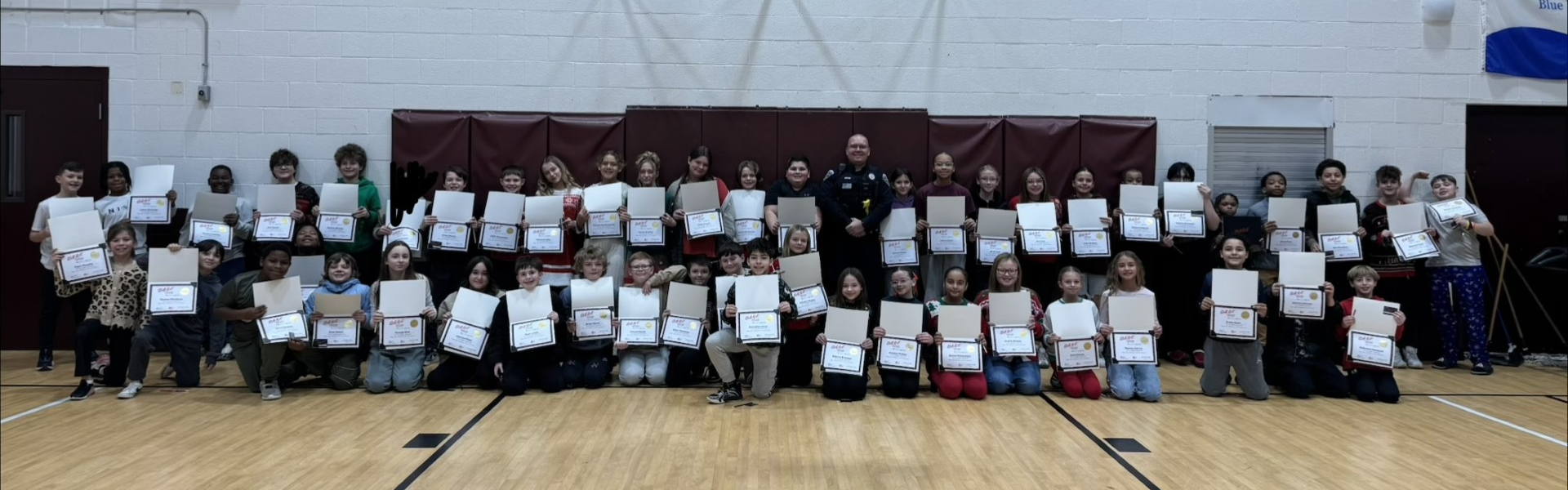 A group of 5th grade students holding DARE certificates
