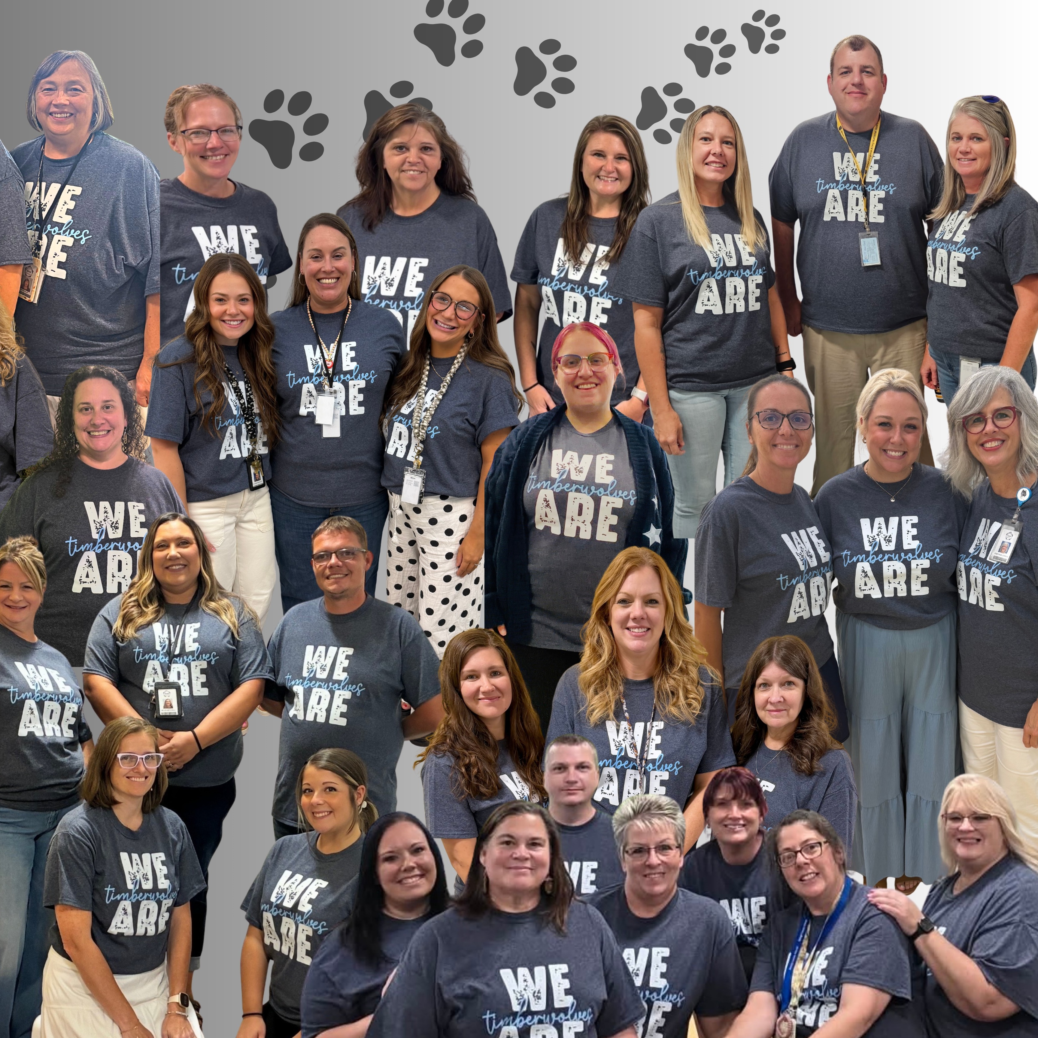 Group of adults in T-shirts stand in front of a paw print design. Some wear glasses.