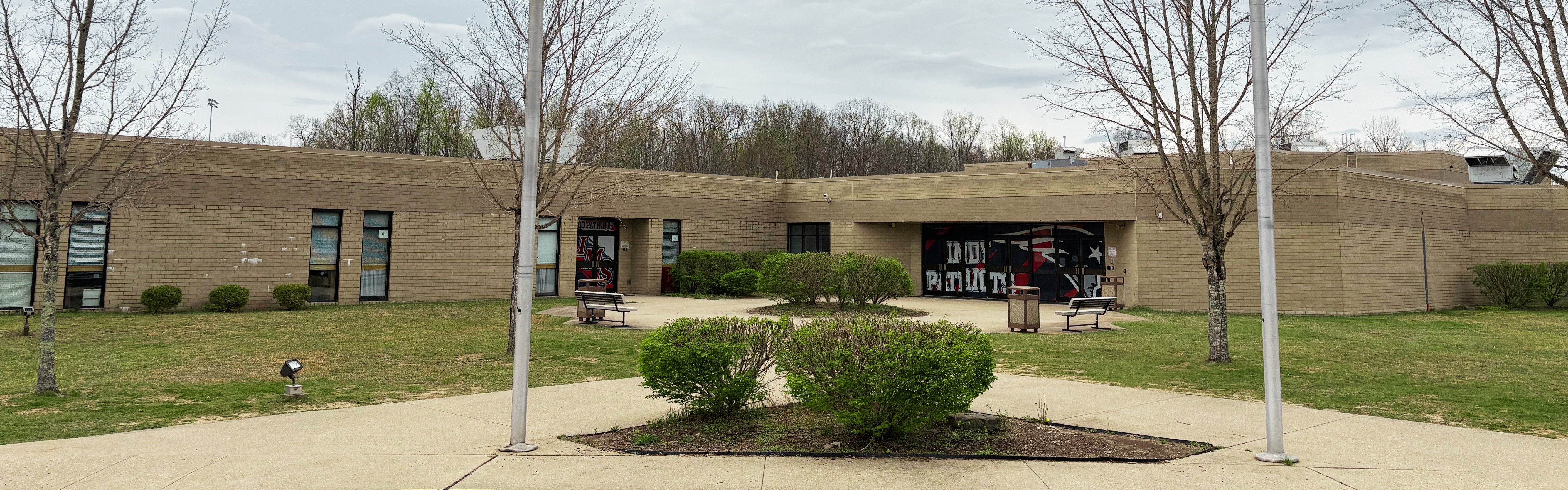 School entrance with flag poles