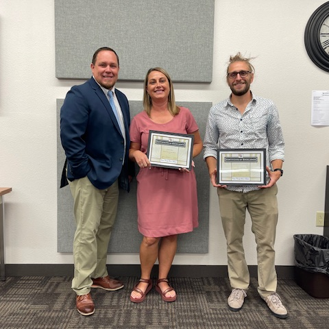 Principal honoring 2 employees for employee of the month