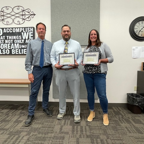 Principal honoring 2 employees for employee of the month