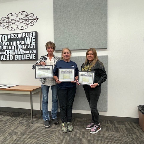 Employee of the Month holding a framed certificate