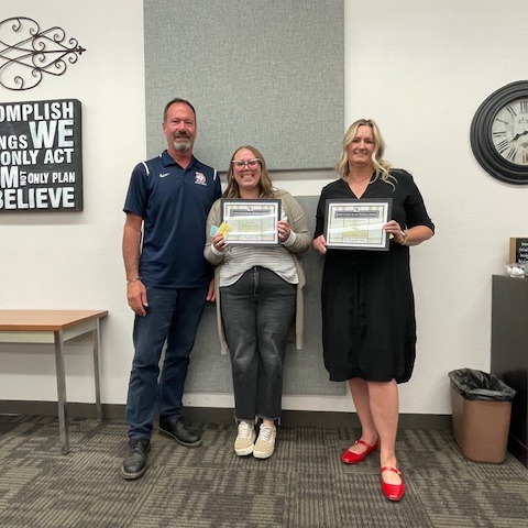Employee of the Month holding a framed certificate