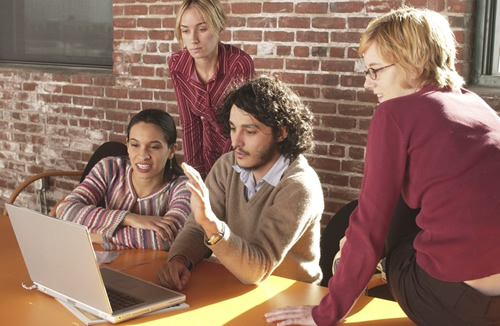 group of people looking at computer screen